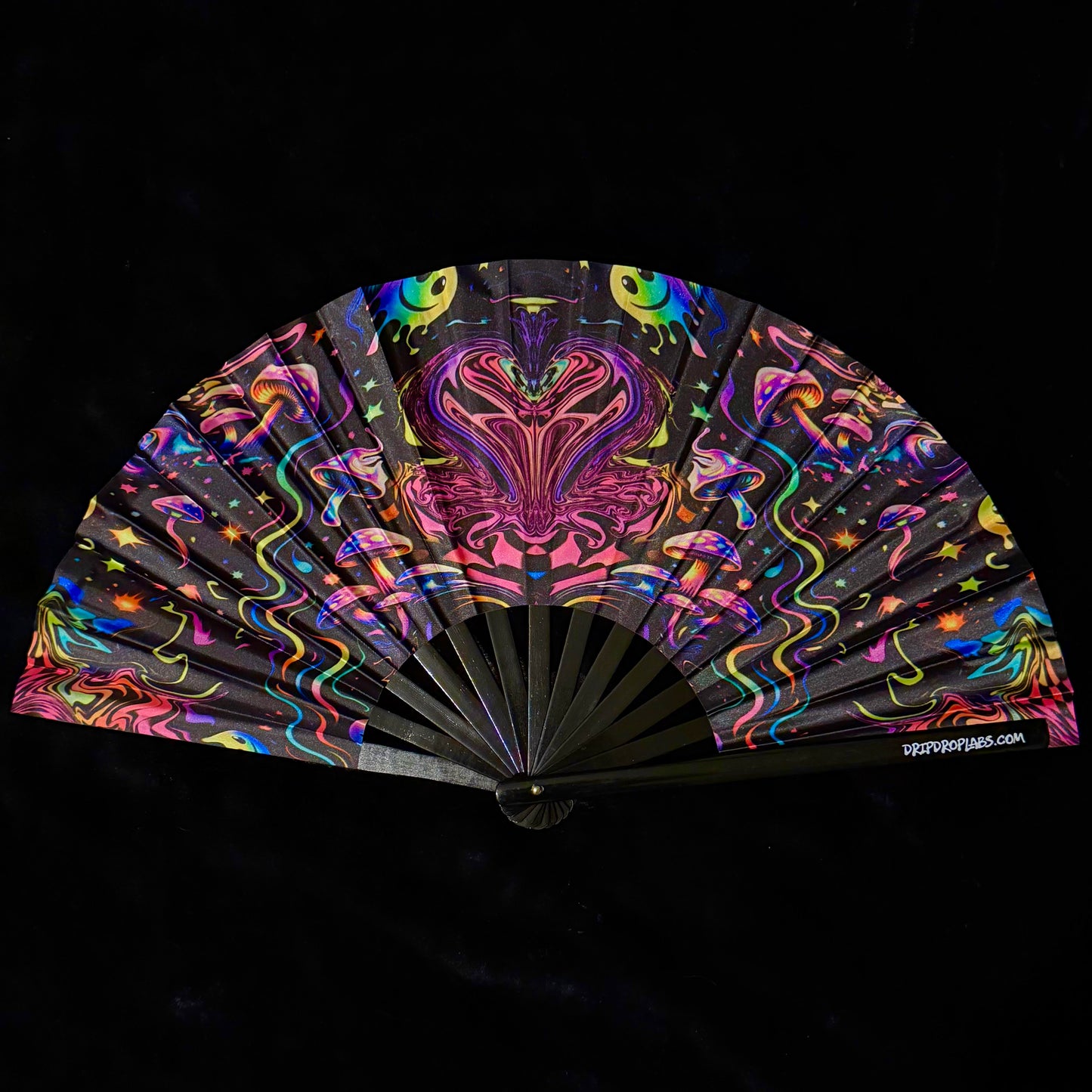 Colorful hand fan with abstract design on a black background
