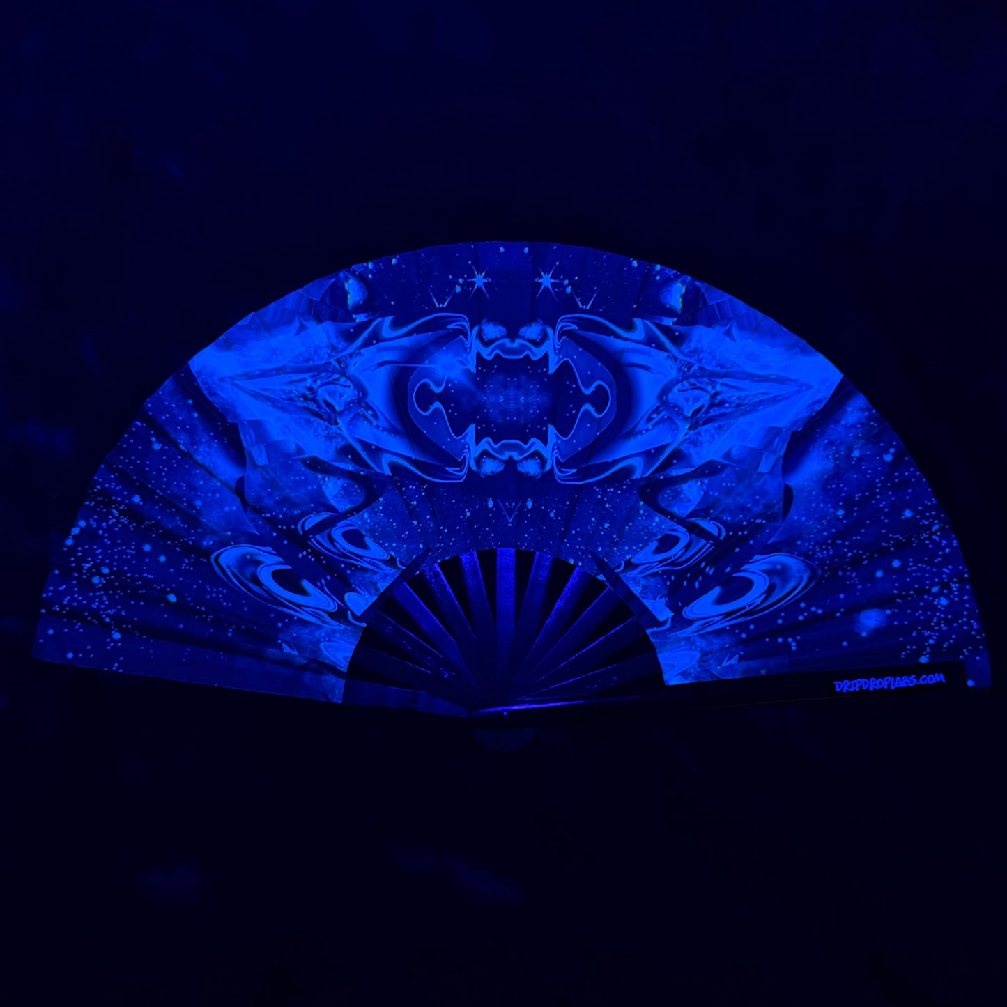 Glowing fan with intricate space patterns on a black background by drip drop labs