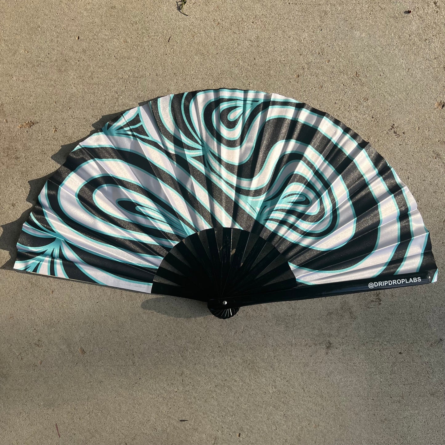 Blue Waves Glow Fan by Drip Drop Labs, a stylish fan with a blue wave design and glowing features, perfect for cooling and decoration.