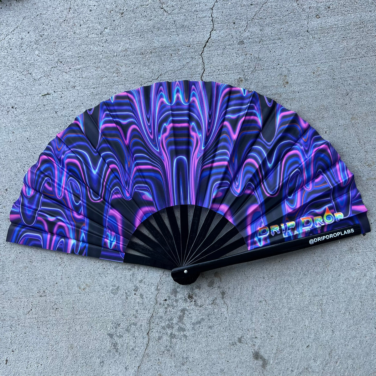 Purple Glow Fan by Drip Drop Labs with drip pattern, illuminated with vibrant purple light, designed for stylish cooling.