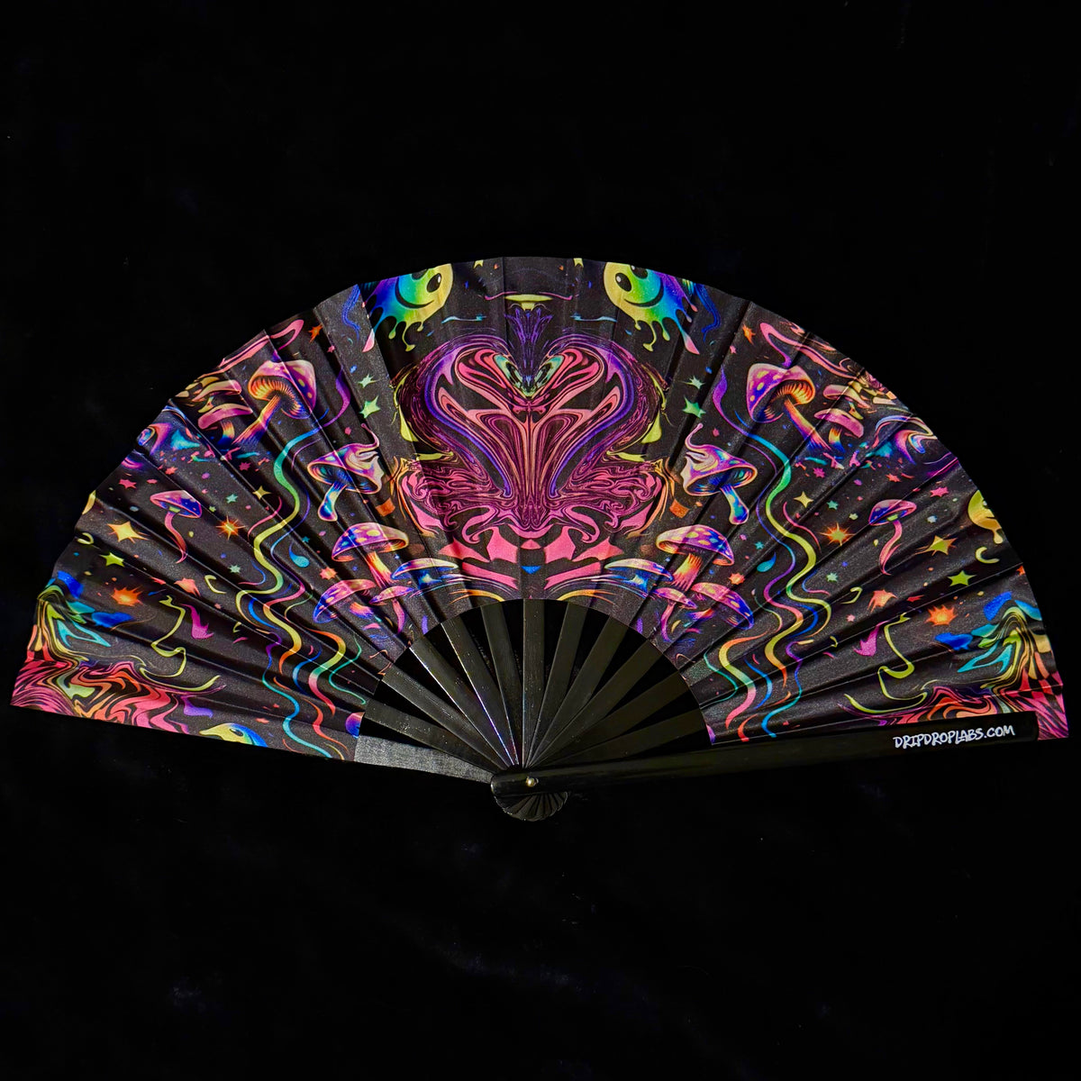 Colorful hand fan with abstract design on a black background