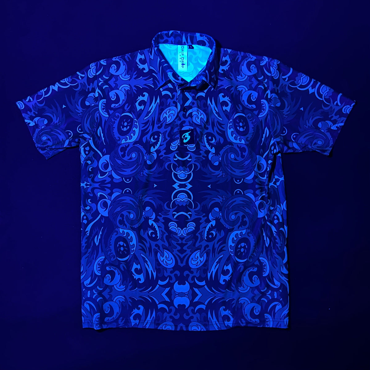 Drip Drop Labs Shadow Forest Polo shirt with dark leafy pattern, classic collar, and button closure, casual men's apparel.