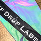 Reflective parachute pants by Drip Drop Labs featuring shiny, lightweight fabric and adjustable waistband for a trendy streetwear look.