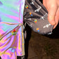 Reflective parachute pants by Drip Drop Labs featuring shiny fabric, loose fit, and adjustable waistband for a stylish streetwear look.