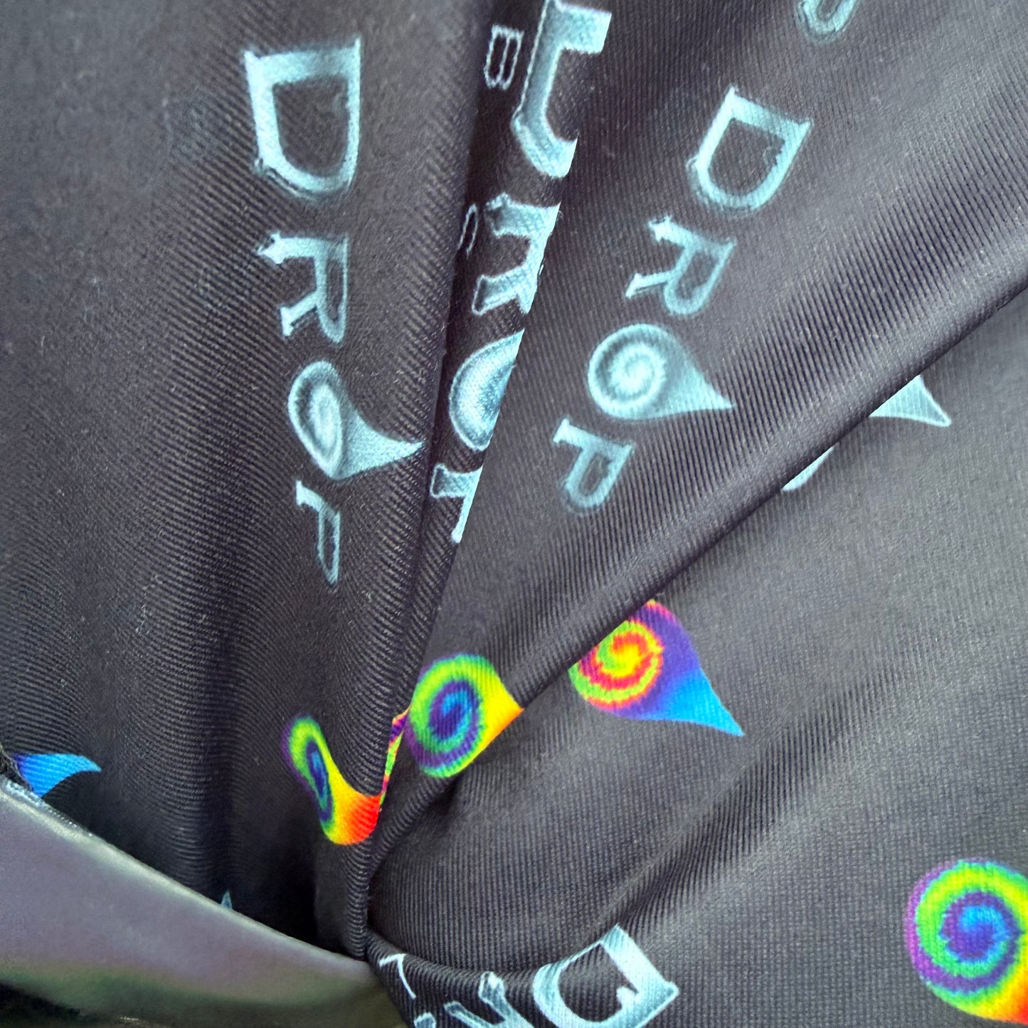 Reflective parachute pants by Drip Drop Labs featuring shiny fabric, adjustable waistband, and tapered design for a sporty look.