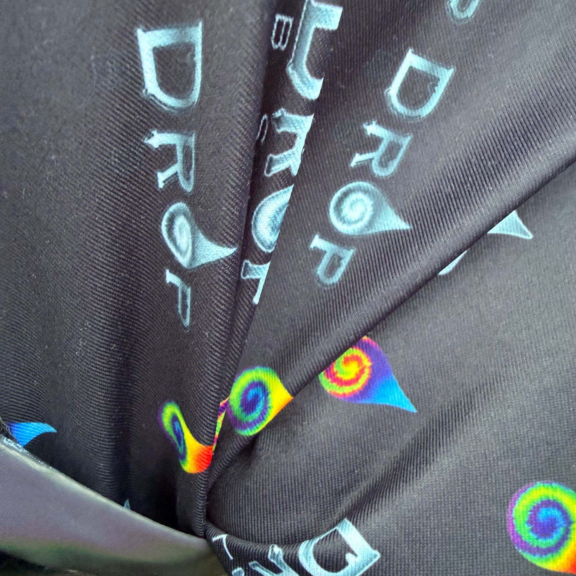 Reflective parachute pants by Drip Drop Labs featuring shiny fabric, adjustable waistband, and tapered design for a sporty look.