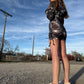 Dark galactic-themed hooded rave romper by Drip Drop Labs featuring vibrant cosmic print and festival-ready fit.