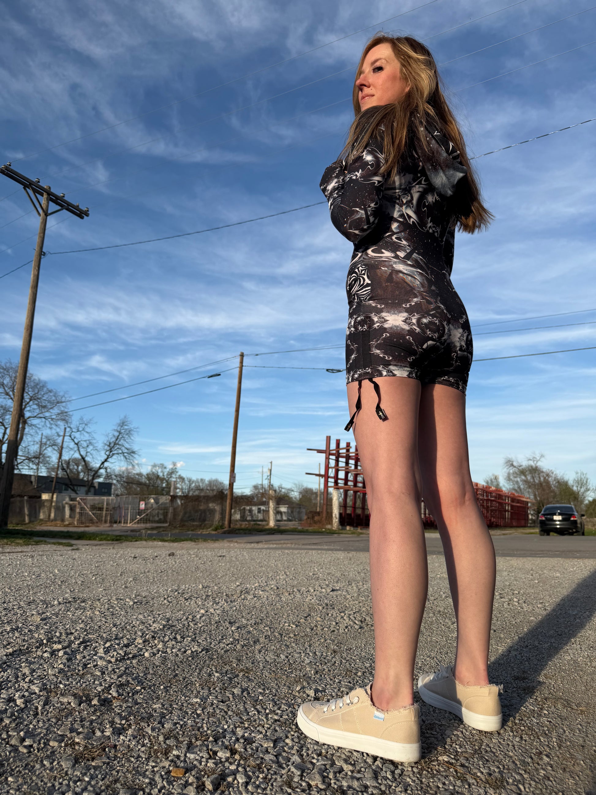 Dark galactic-themed hooded rave romper by Drip Drop Labs featuring vibrant cosmic print and festival-ready fit.