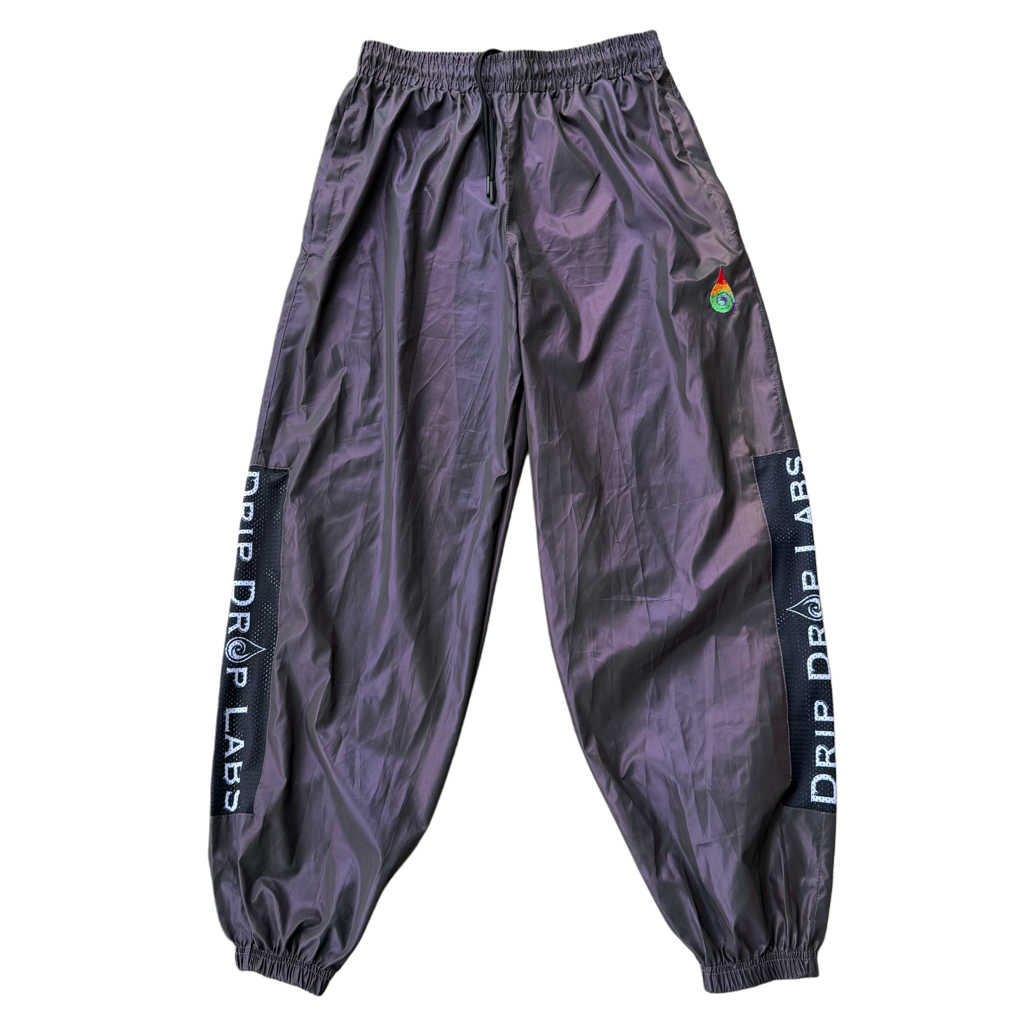 Reflective parachute pants by Drip Drop Labs featuring lightweight fabric, adjustable waistband, and reflective detailing.
