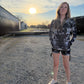 Dark galactic-themed hooded rave romper by Drip Drop Labs with vibrant starry patterns and a comfortable festival fit.