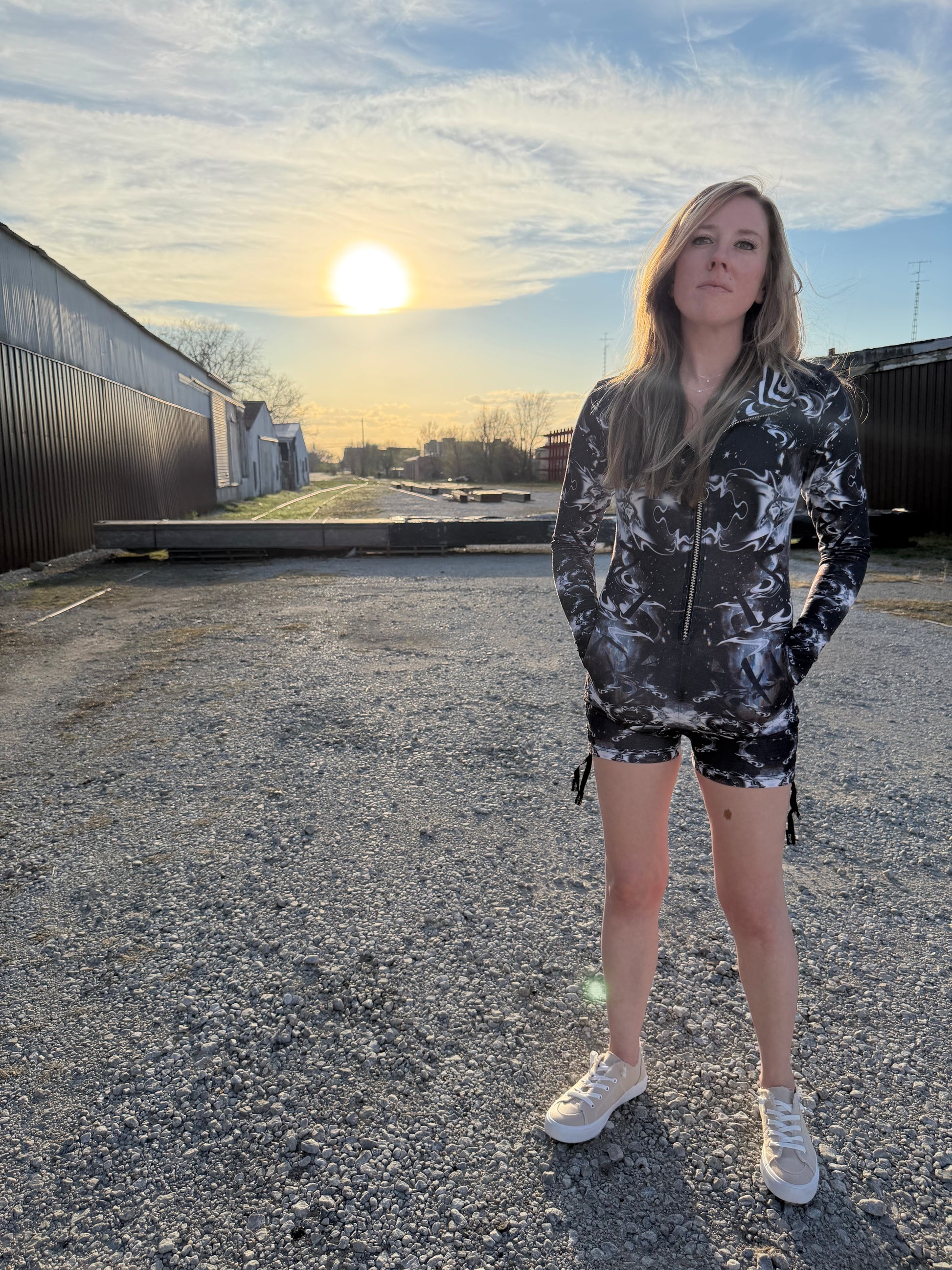 Dark galactic-themed hooded rave romper by Drip Drop Labs with vibrant starry patterns and a comfortable festival fit.