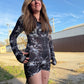 Dark galactic rave romper with hood from Drip Drop Labs featuring vibrant space-themed patterns and luminous fabric details.