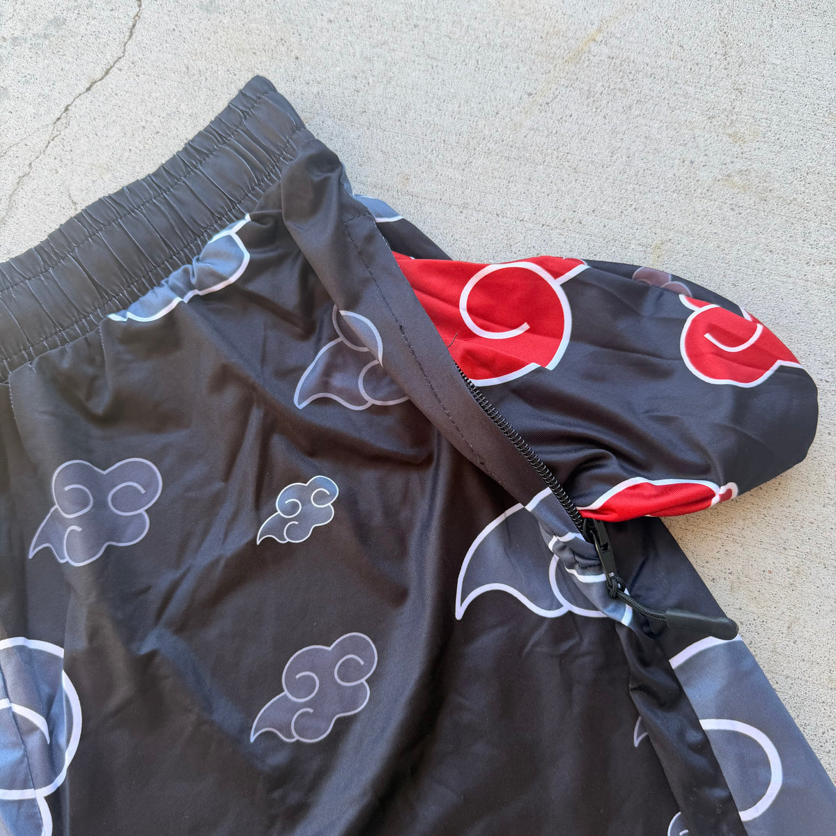 Black AK Drip Cloud Shorts by Drip Drop Labs featuring a relaxed fit and cloud-inspired design, displayed on a hanger.