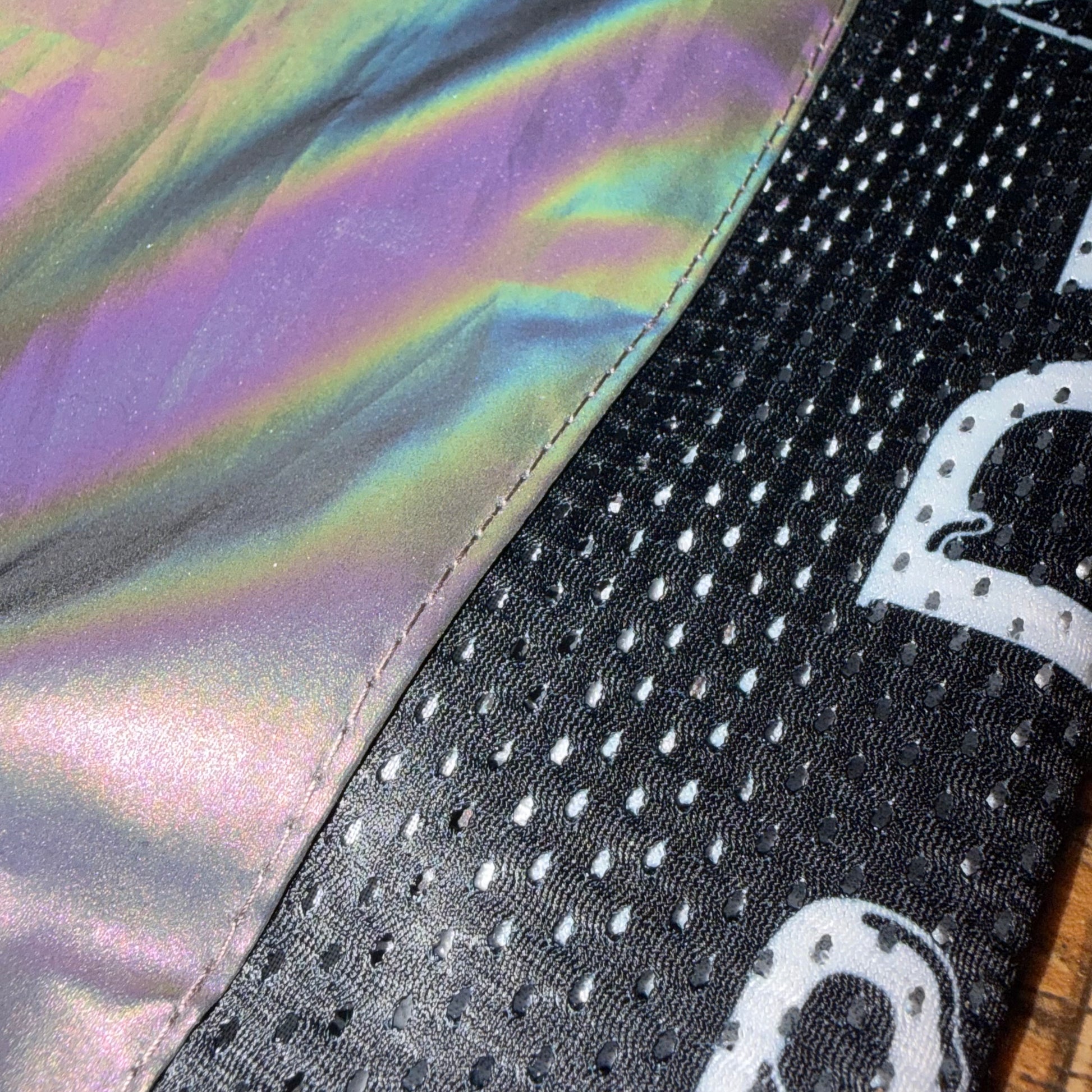 Reflective Drip Drop Labs parachute pants with shiny, metallic fabric and elastic waistband, designed for a stylish, sporty look.