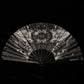 Black and white fan with abstract design on a black background