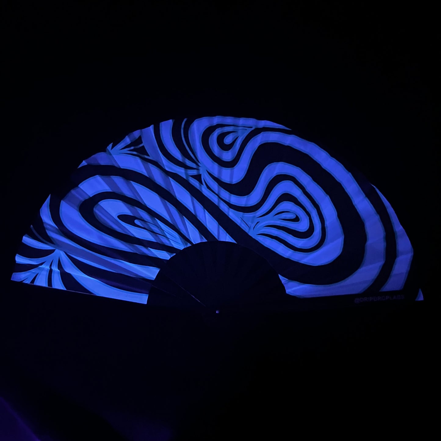Blue Waves Glow Fan by Drip Drop Labs, a vibrant blue LED fan with wave-inspired design, glowing in the dark.