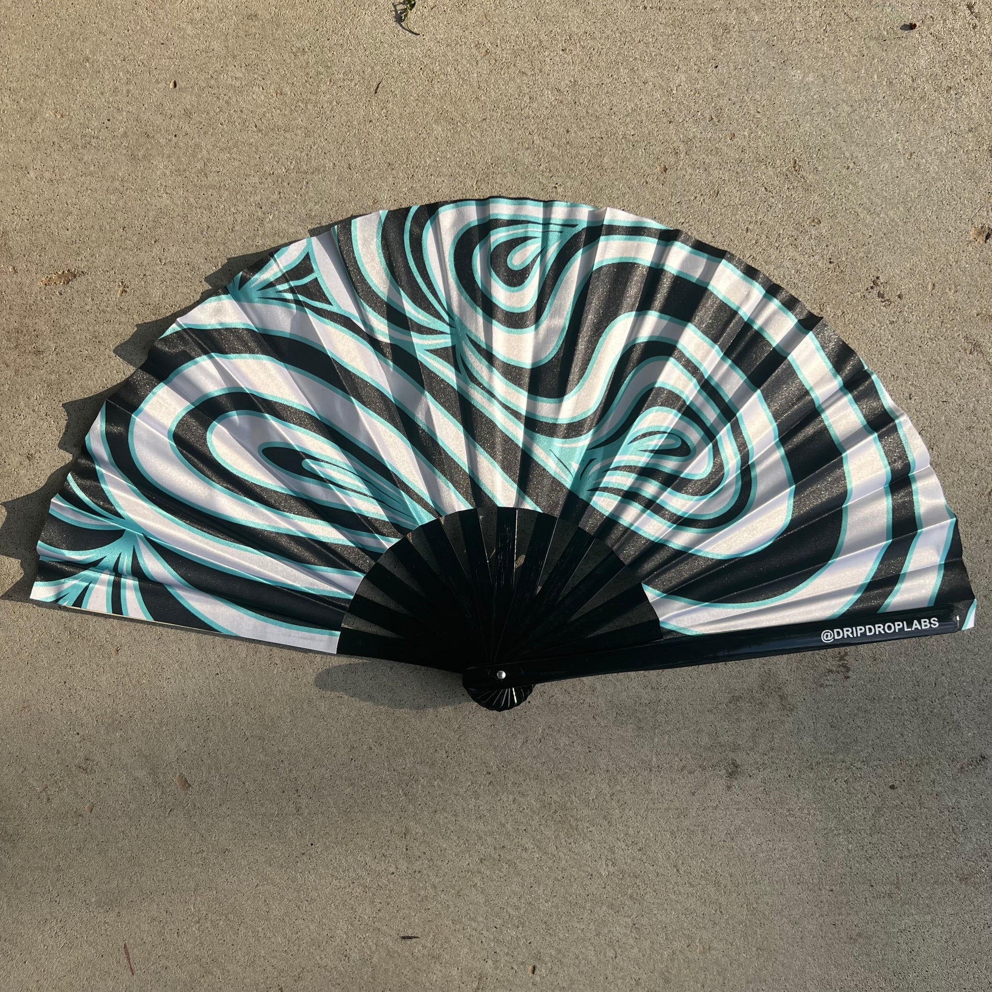 Blue Waves Glow Fan by Drip Drop Labs, a stylish fan with a blue wave design and glowing features, perfect for cooling and decoration.