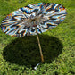 Drip Drop Labs Chromatic Shadow OG Parasol with vibrant, multicolored fabric and black handle, designed for stylish shade.