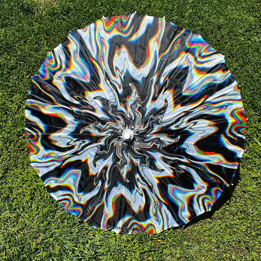 Drip Drop Labs Chromatic Shadow OG parasol featuring a vibrant, colorful canopy with a sleek black handle.