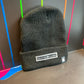 Black Drip Drop Labs beanie hat with embroidered logo, cozy knit material, designed for warmth and casual style.
