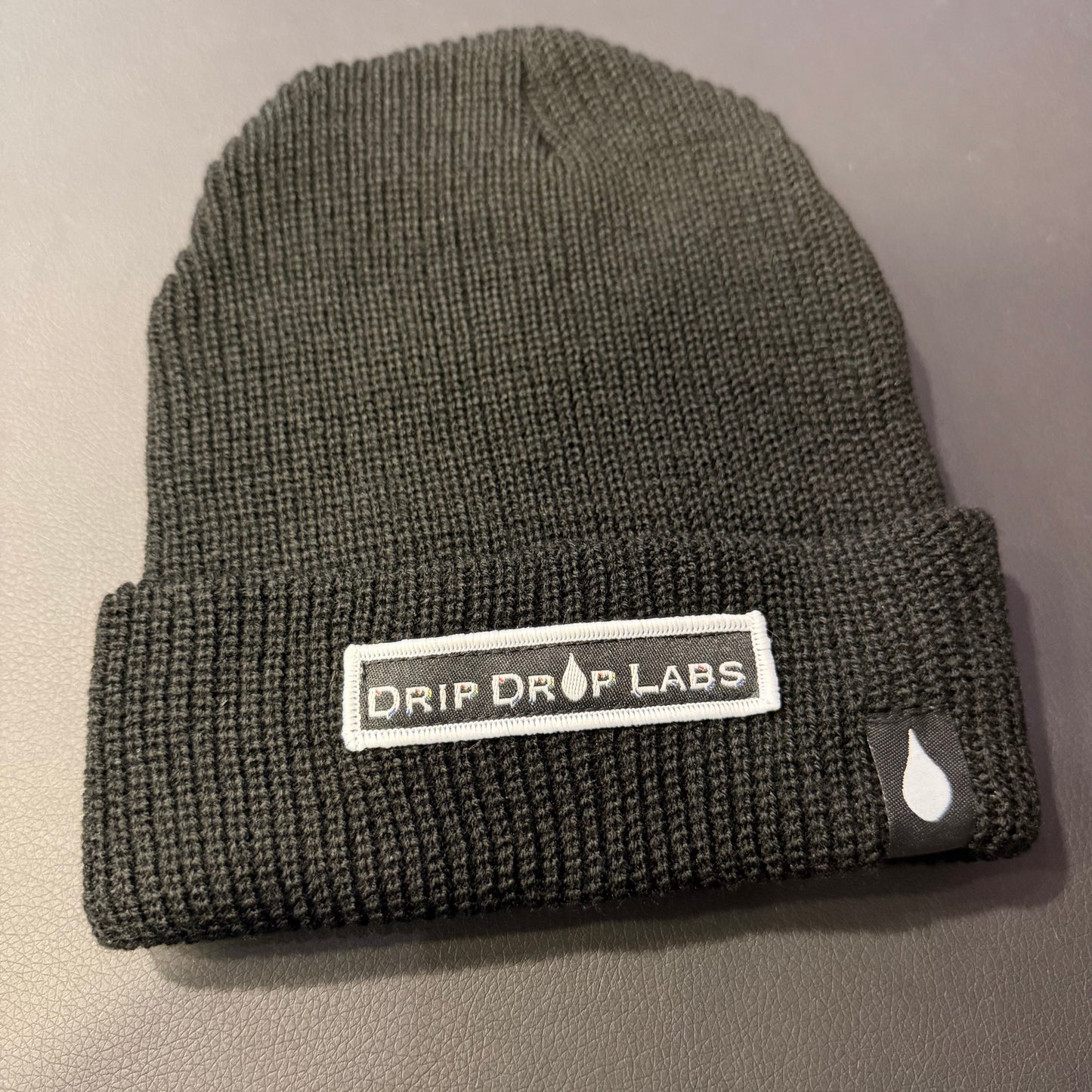 Drip Drop Labs beanie in black with logo patch, cozy knit cap for warmth and style.
