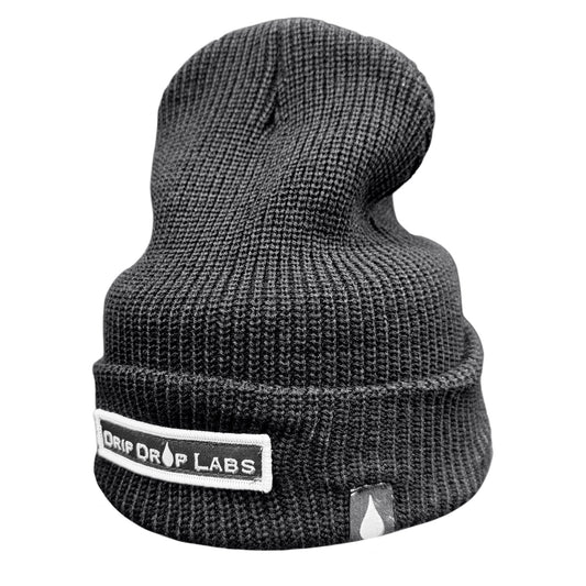 Orange Drip Drop Labs beanie with black logo patch, knit fabric, and snug fit, perfect for cold weather.