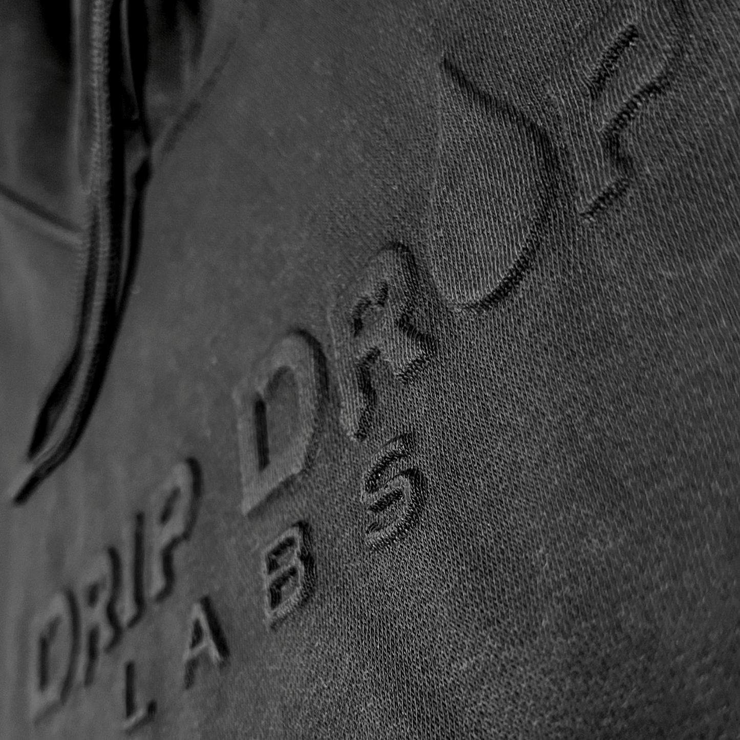 Drip Drop Labs embossed athletic hoodie in black with textured logo detailing and a comfortable fit.