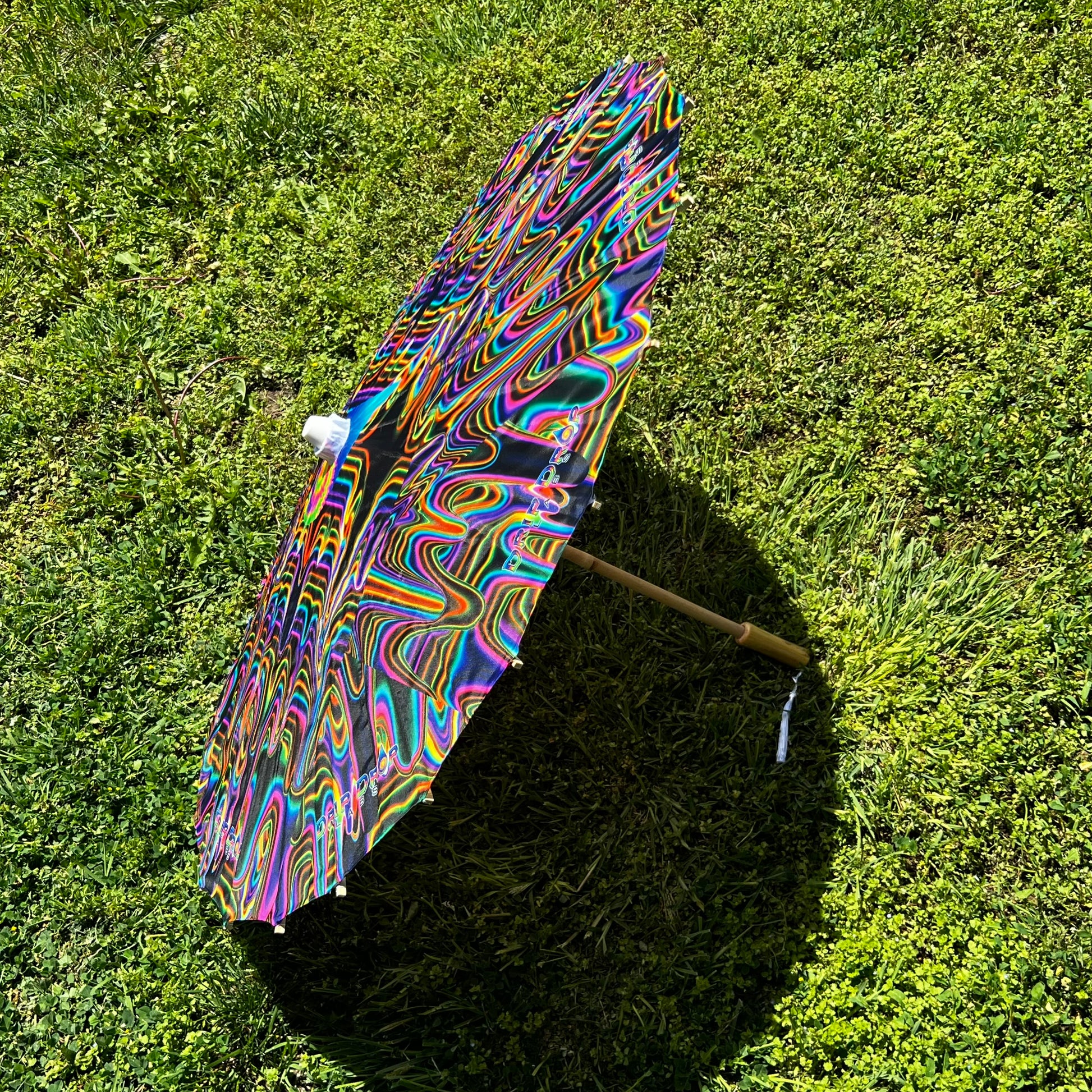 Drip Drop Labs OG Parasol in vibrant colors, lightweight parasol with a sleek design, perfect for sun protection and style.