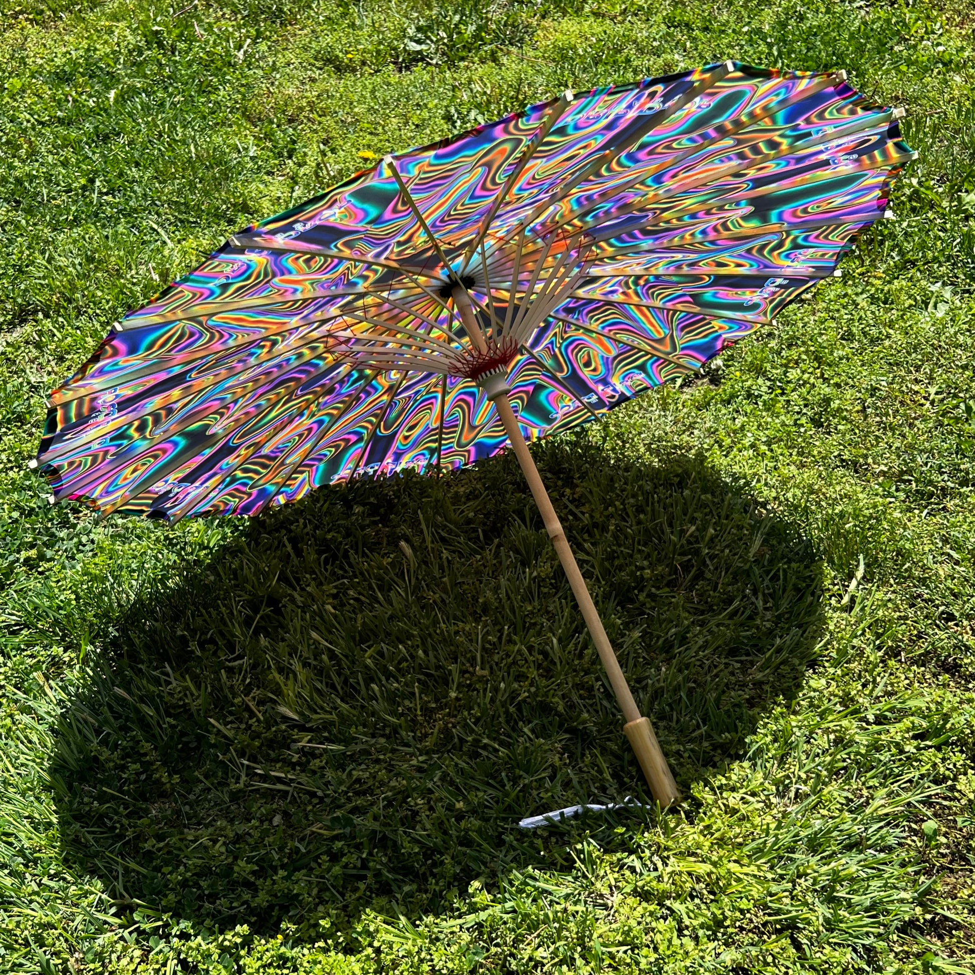 Drip Drop Labs OG Parasol open with detailed fabric canopy and wooden handle, showcasing a stylish parasol design.
