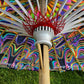 Drip Drop Labs OG Parasol with vibrant, colorful canopy and wooden handle, open and displayed outdoors.