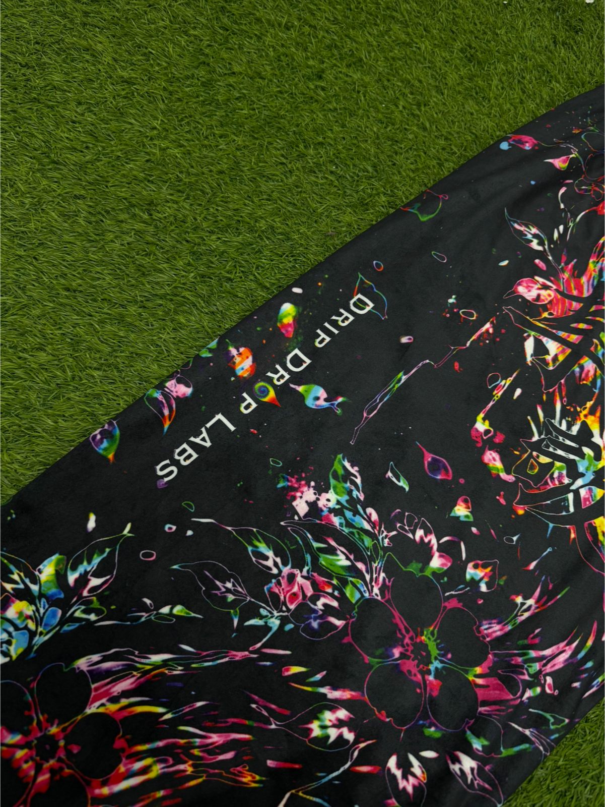 Limited edition Drip Drop Labs Velvet Parachute Pants with a vibrant Frequency Bloom pattern and relaxed fit.
