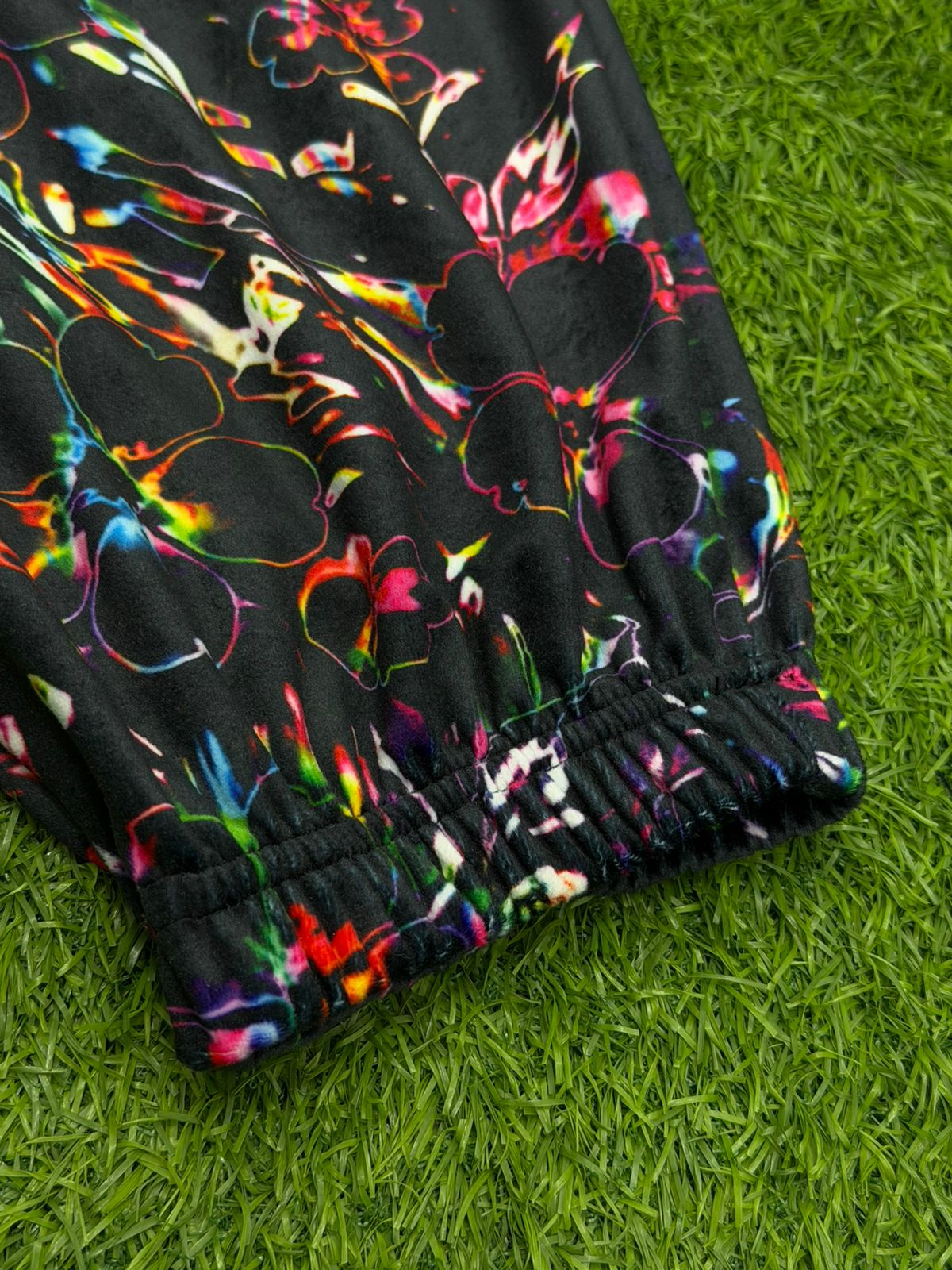 Limited edition Drip Drop Labs Frequency Bloom velvet parachute pants with vibrant floral design and relaxed fit.