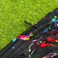 Limited edition Drip Drop Labs Frequency Bloom velvet parachute pants with vibrant floral pattern and relaxed fit.