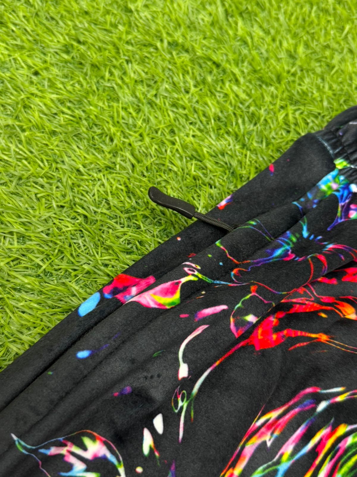 Limited edition Drip Drop Labs Frequency Bloom velvet parachute pants with vibrant floral pattern and relaxed fit.