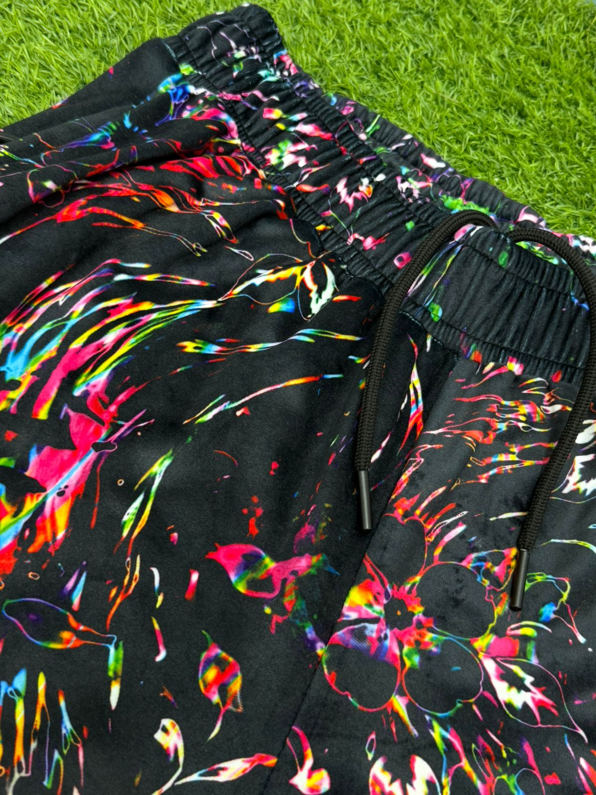 Limited edition Drip Drop Labs Velvet Parachute Pants with vibrant Frequency Bloom pattern, soft velvet fabric and relaxed fit.