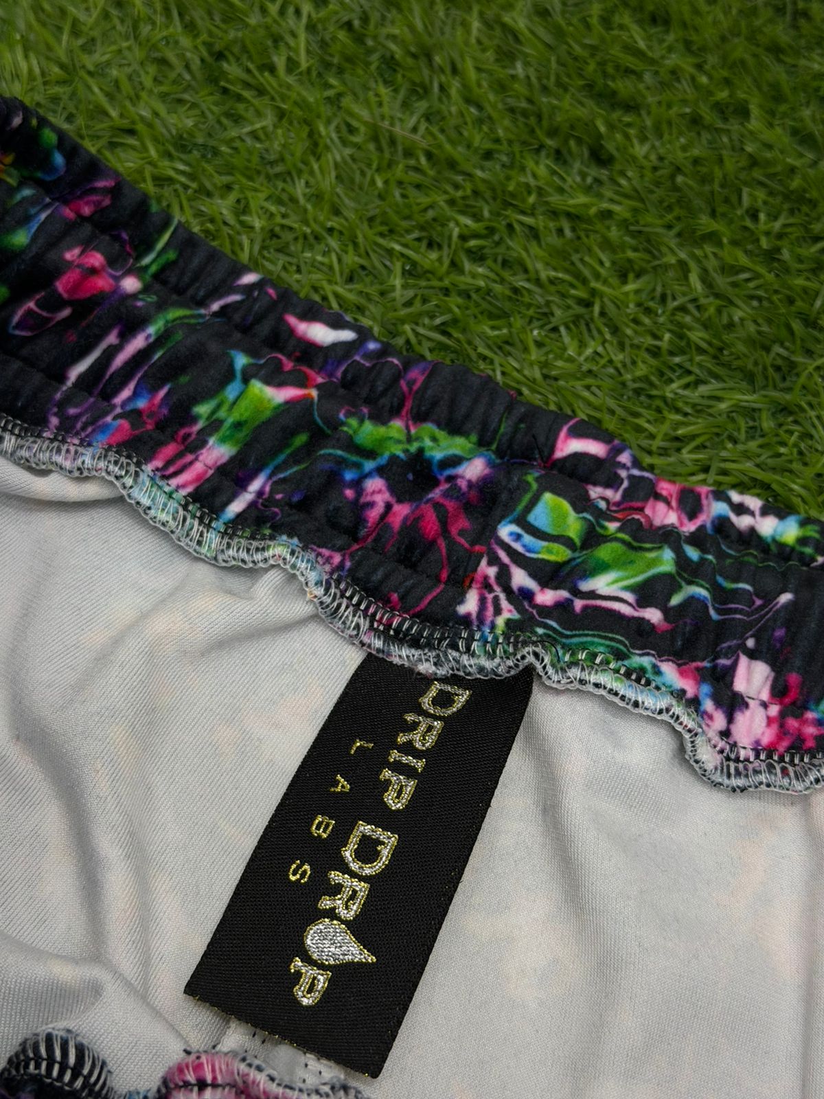 Limited edition Drip Drop Labs Frequency Bloom velvet parachute pants with vibrant floral design and relaxed fit.