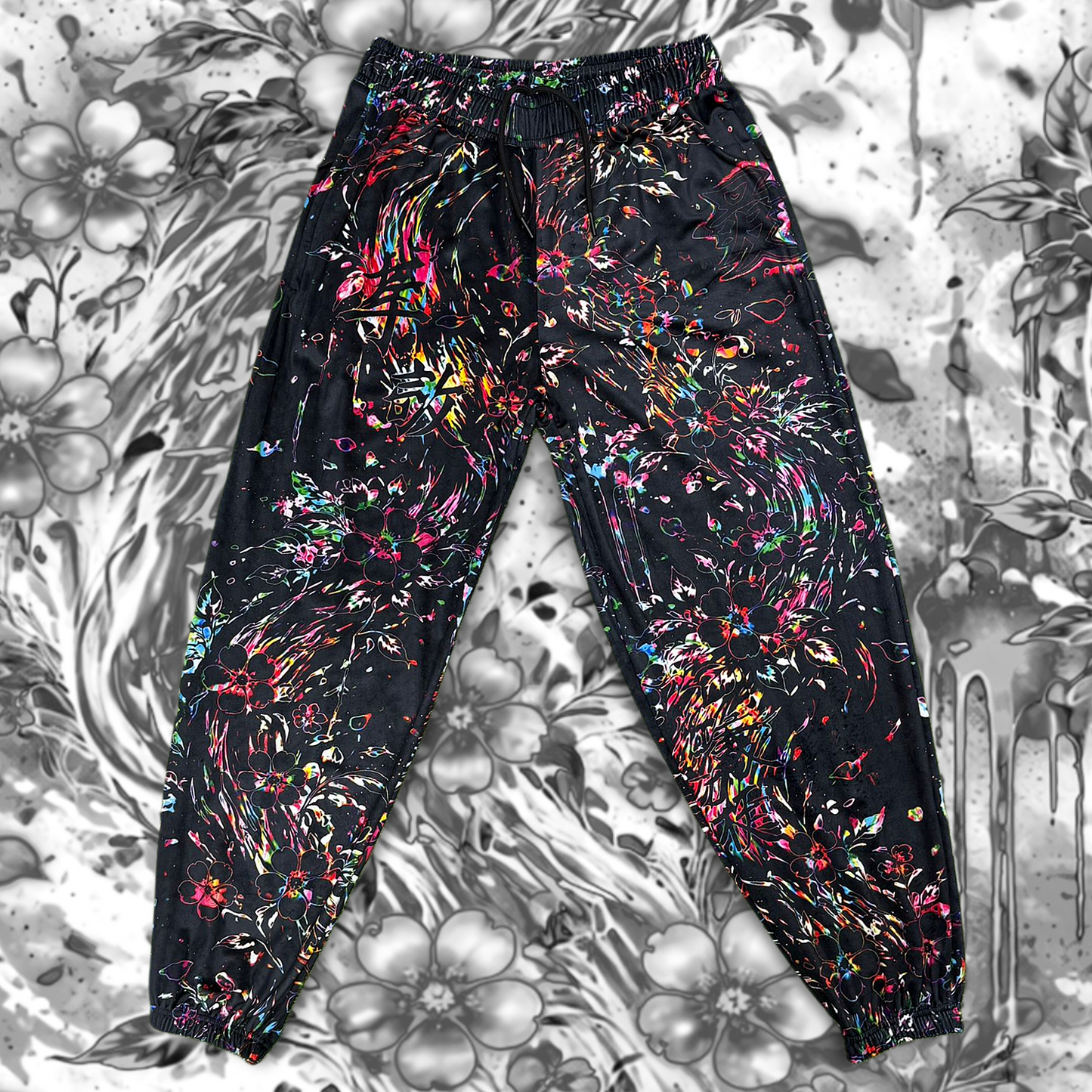 Limited edition Drip Drop Labs Frequency Bloom velvet parachute pants with vibrant floral pattern and relaxed fit.