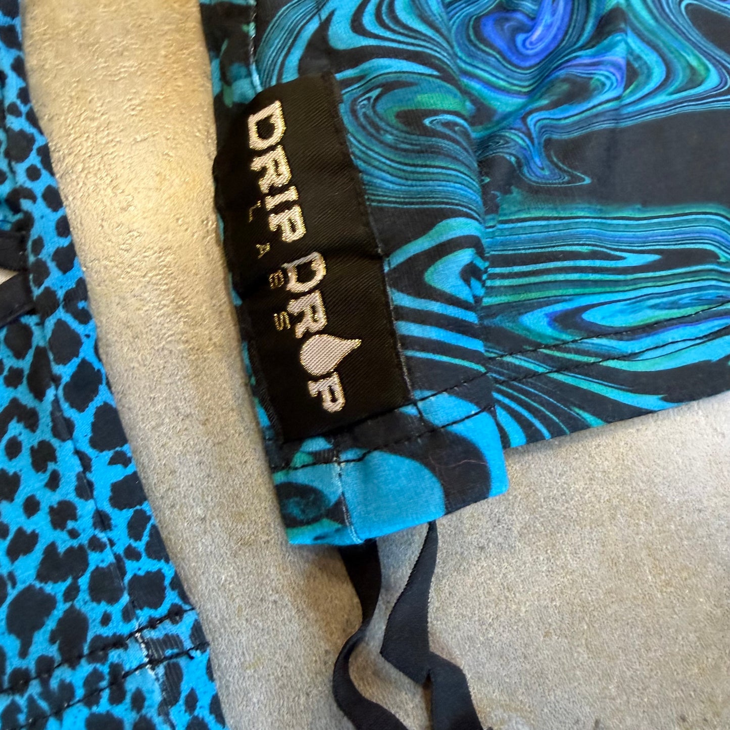 Drip Drop Labs Glitch Instinct Hooded Rave Romper featuring cyber animal print, vibrant colors, and festival-ready fit.