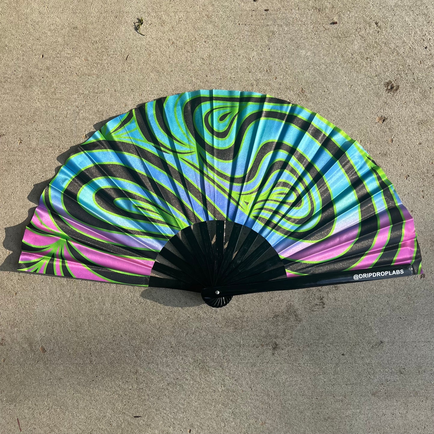 Drip Drop Labs Neon Waves Glow Fan displaying vibrant neon wave patterns with a sleek, modern fan design.