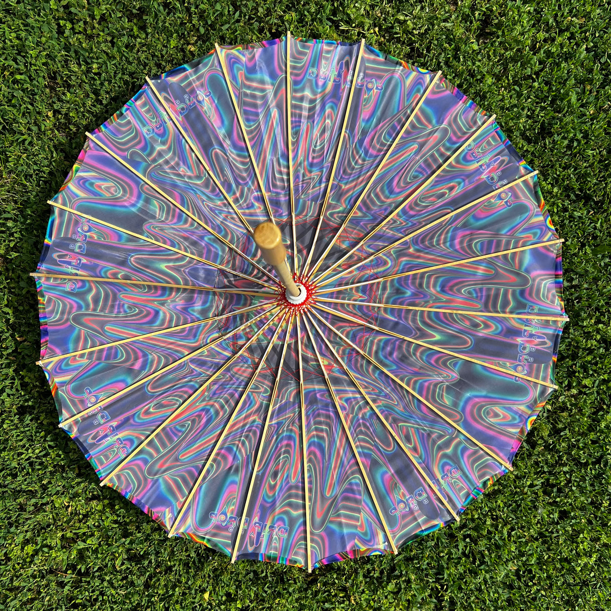 Drip Drop Labs OG Parasol, a stylish umbrella with a vibrant design, open to showcase its colorful fabric and sturdy frame.