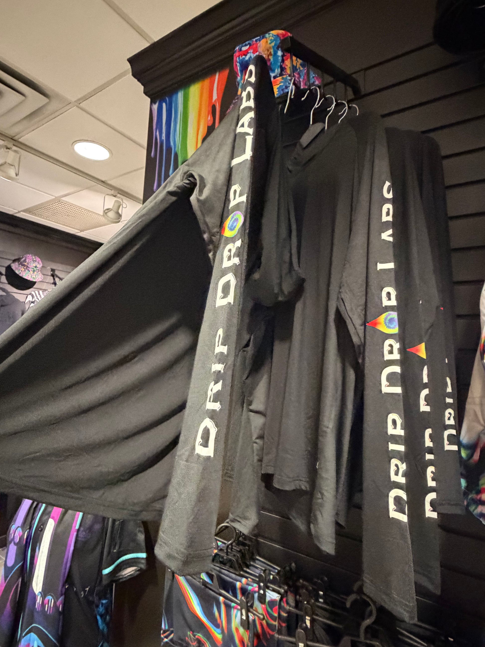 Black Drip Drop Labs athletic hoodie with performance fabric, featuring a hood, logo on chest, and sporty design.