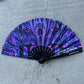 Purple Glow Fan by Drip Drop Labs with drip pattern, illuminated with vibrant purple light, designed for stylish cooling.