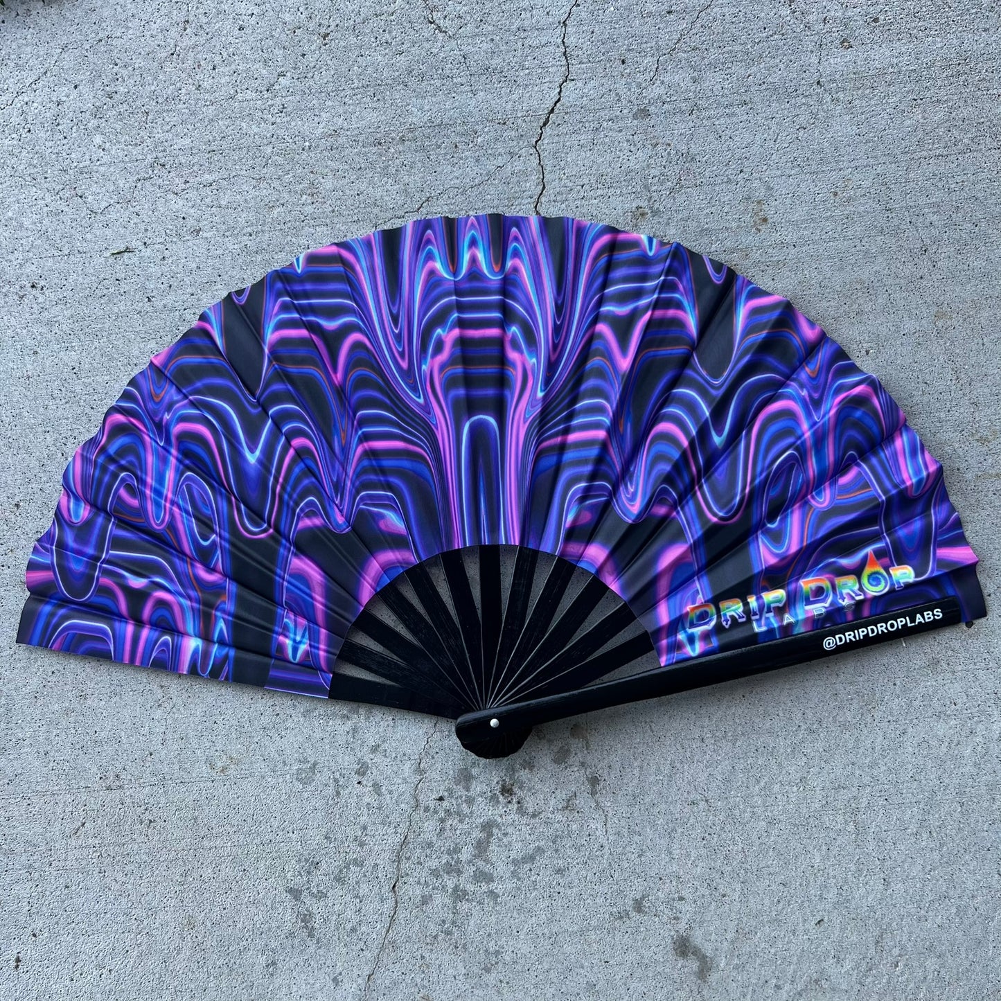 Purple Glow Fan by Drip Drop Labs with drip pattern, illuminated with vibrant purple light, designed for stylish cooling.