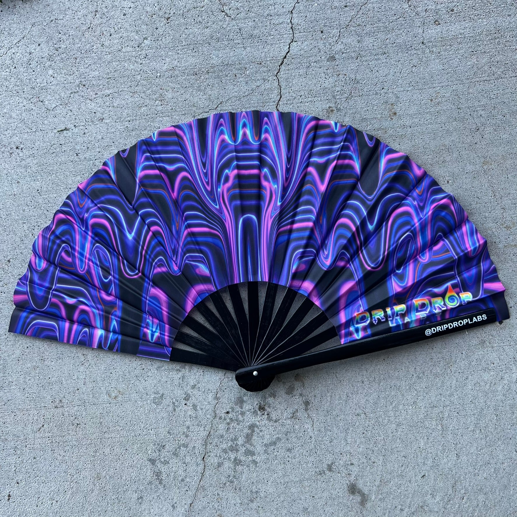 Purple Glow Fan by Drip Drop Labs with drip pattern, illuminated with vibrant purple light, designed for stylish cooling.