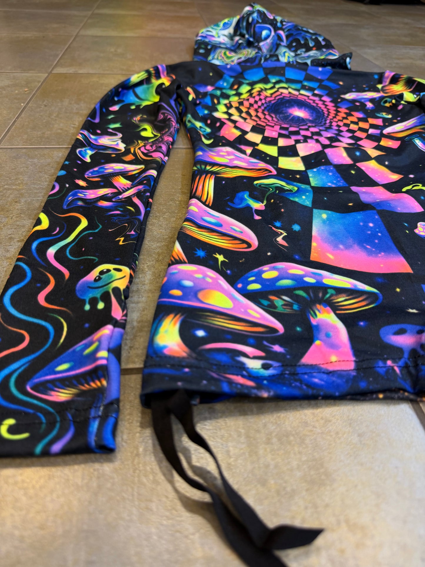 Rainbow Portal Hooded Rave Romper by Drip Drop Labs featuring psychedelic rainbow patterns and a hood, perfect for festival wear.
