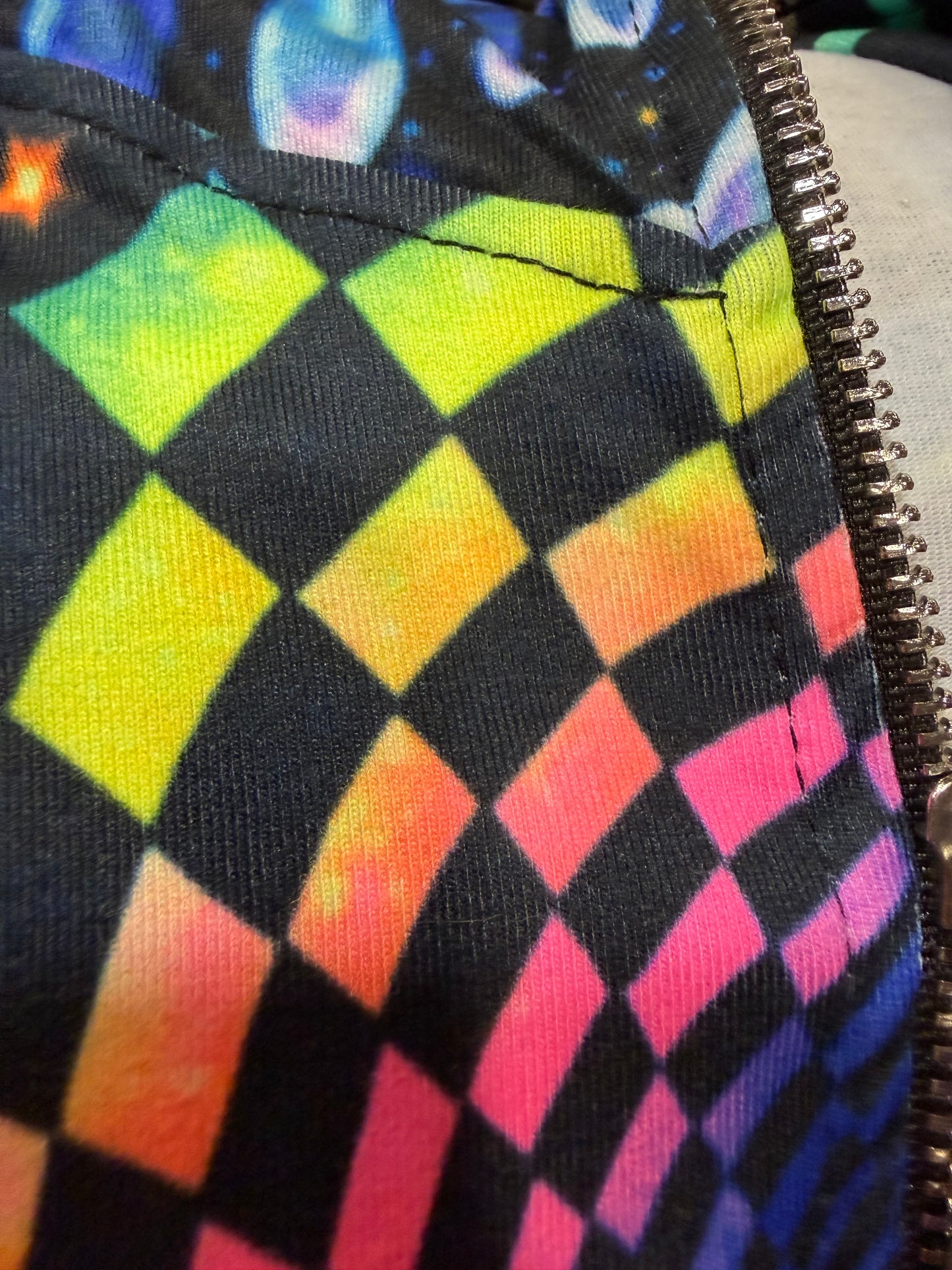Rainbow Portal Hooded Rave Romper by Drip Drop Labs featuring vibrant psychedelic colors and a hood, perfect for festival outfits.