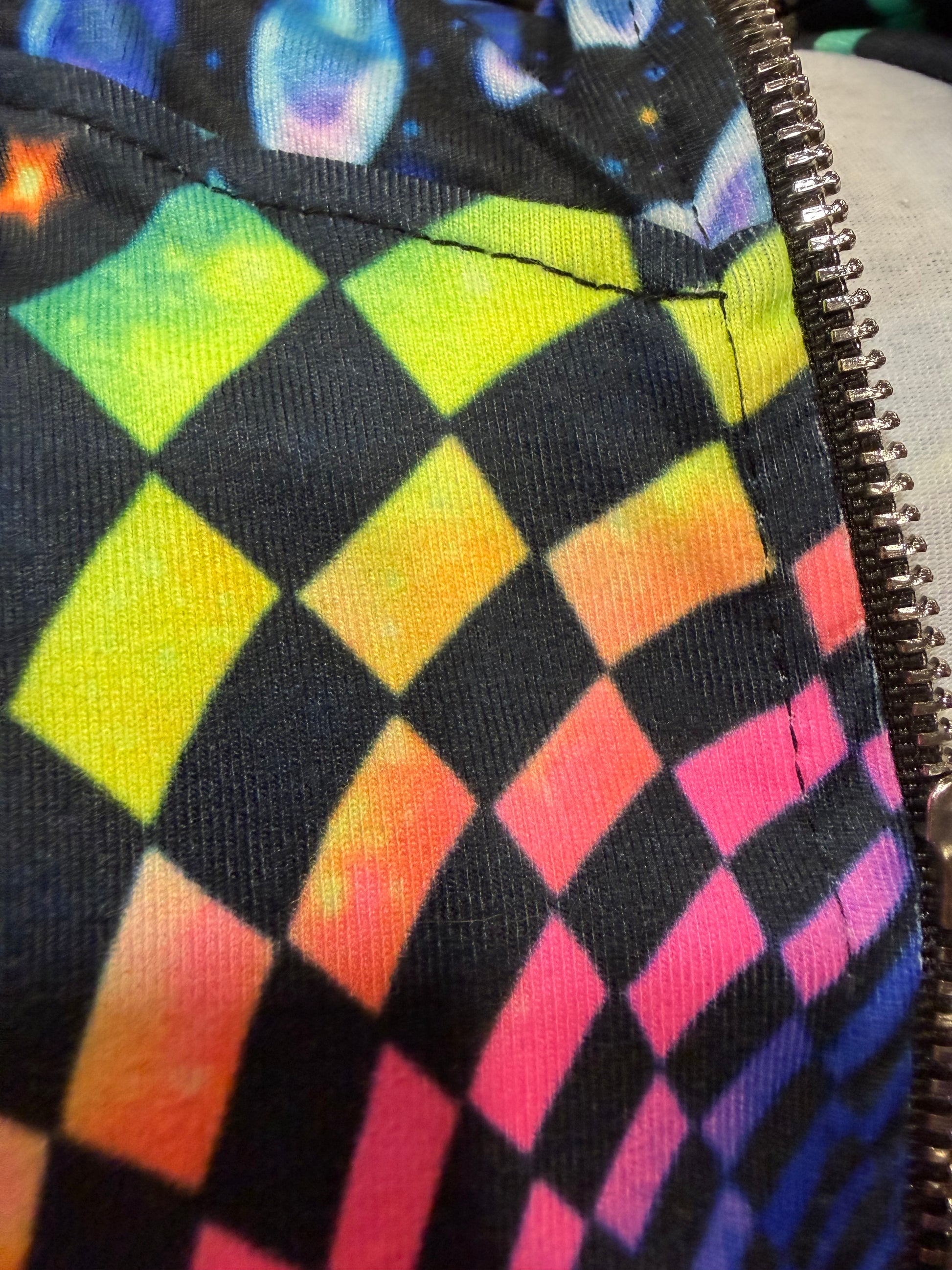 Rainbow Portal Hooded Rave Romper by Drip Drop Labs featuring vibrant psychedelic colors and a hood, perfect for festival outfits.