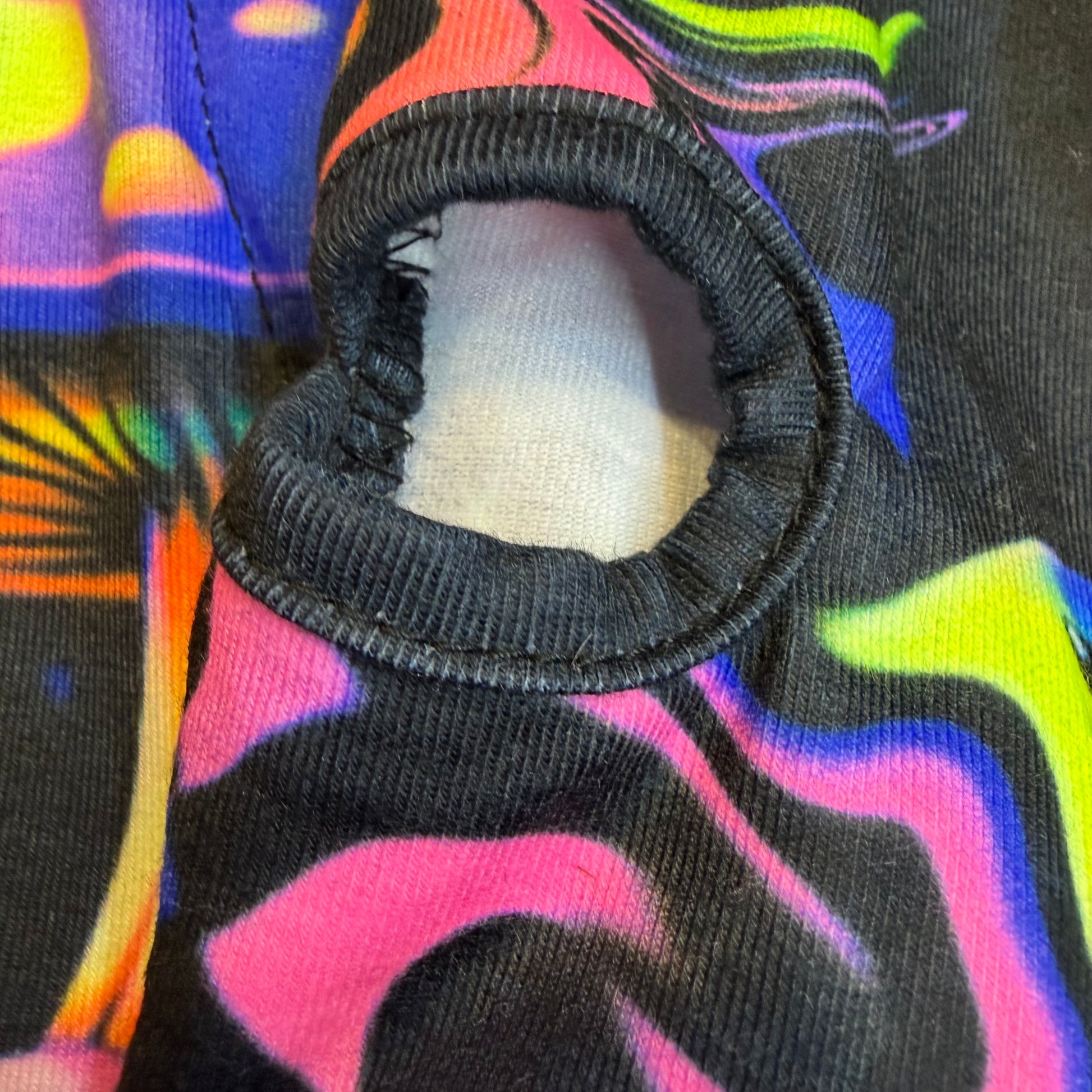 Rainbow Portal Hooded Rave Romper by Drip Drop Labs featuring a psychedelic festival fit with vibrant rainbow colors and a hooded design.