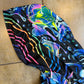 Rainbow Portal Hooded Rave Romper by Drip Drop Labs featuring a psychedelic rainbow design and hood, perfect for festival wear.