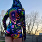 Rainbow portal hooded rave romper by Drip Drop Labs featuring psychedelic festival-inspired design and vibrant, colorful patterns.